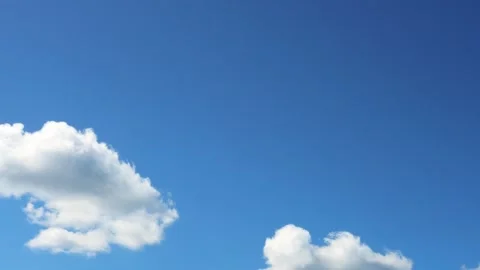 White clouds float gently in the blue sky forming serene and peaceful scene Stock Footage 282200083