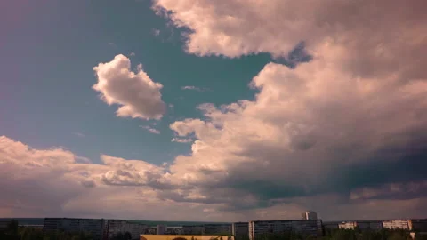 White clouds float over residential buildings casting shadows on them.  Stock Footage 142079636