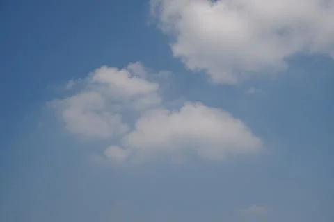 White Clouds Floating Across a Clear Blue Summer Sky Stock Photos