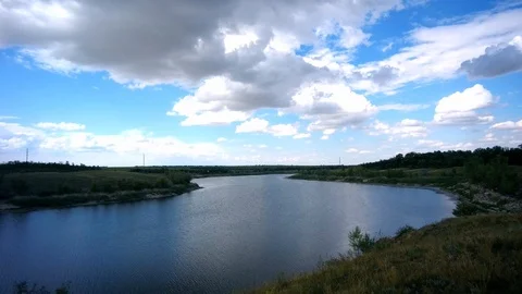 White clouds floating against the blue sky above the river Stock Footage 94061261