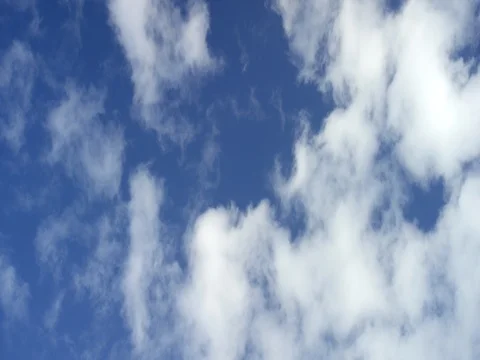 White clouds floating in blue sky on a sunny day Stock Footage