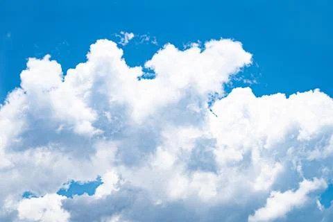 White clouds floating in the blue sky. Stock Photos
