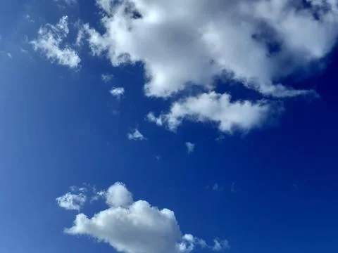 White Clouds Floating in Blue Sky. Cloudy landscape. Sunny summer day. Stock Photos