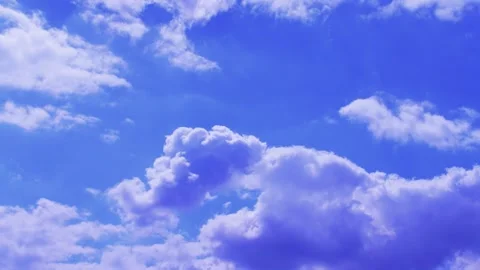 White clouds floating in a bright blue summer sky Stock Footage 327592295