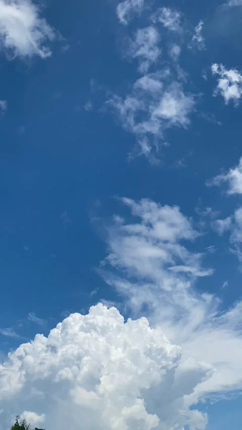 White Clouds Floating in Clear Blue Sky Stock Footage 326915376