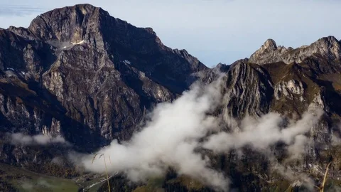 White clouds floating near the rocky mountain Stock-Footage 76004779
