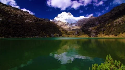 White clouds floating over green lake and mountain Stock Footage 77444944