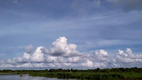 White Clouds Floating Over the Lake in Blue Sky Arrange in Rows HD Timelapse Stock Footage 134320002
