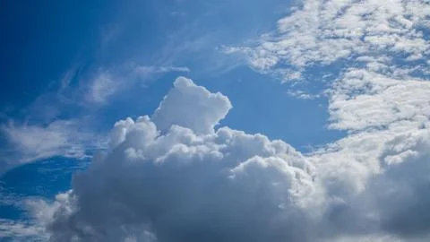 White clouds floating in the sky are caused by steam forming on a bright day. Stock Photos