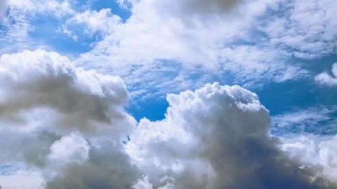 White clouds floating in the sky are caused by steam forming on a bright day. Stock Photos
