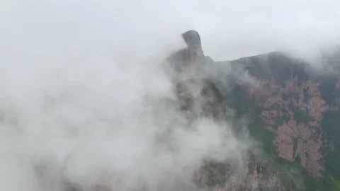 White clouds flowing over mountains Video stock 138884750