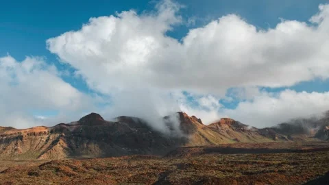 White Clouds Flowing Over Volcanic Mountain Peaks Tenerife 4K Timelapse Stock Footage 334399016