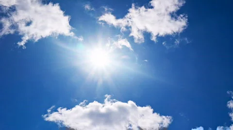 White clouds flying on blue sky with sun rays time-lapse Stock Footage 743975