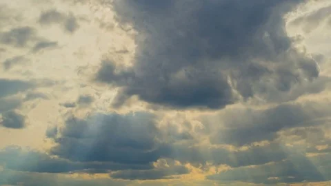 White clouds flying on blue sky with sun rays. Sun beams. Time lapse Stock Footage 74907106