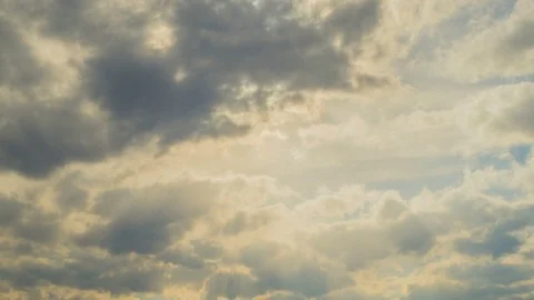 White clouds flying on blue sky with sun rays. Sun beams. Time lapse Stock Footage 74907430