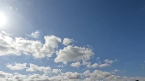 White Clouds Flying On Blue Sky With Sun Rays 2 Stock Footage 216803571