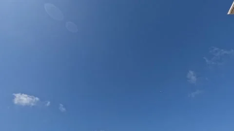 White Clouds Flying On Blue Sky With Sun Rays 3 Stock Footage 216803739