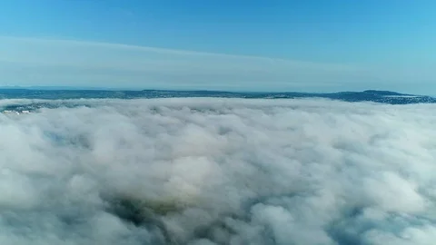 White clouds flying, rolling and morphing covering green summer landscape on Video stock 127173092