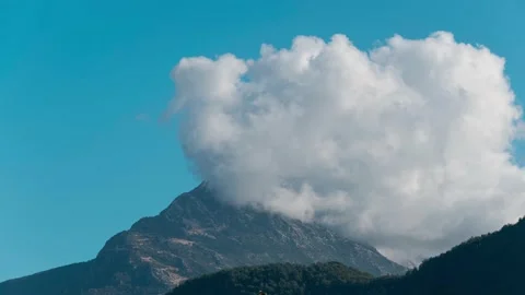 White clouds forming over mountain peak Видео 230166740