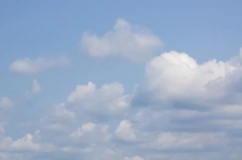 White clouds in front of a blue sky Stock Photos