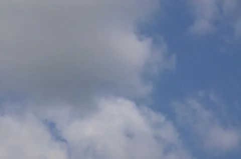 White clouds in front of a blue sky Stock Photos