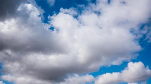 White clouds on a huge blue sky background Stock Photos