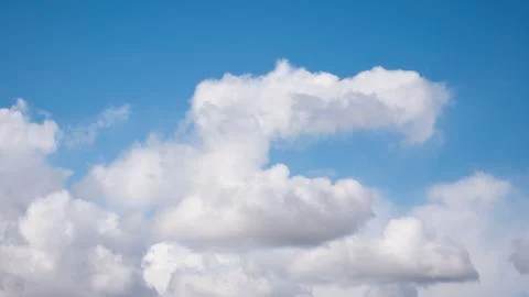White clouds on a huge blue sky background Stock Photos