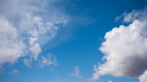 White clouds on a huge blue sky background Stock Photos