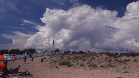 White clouds loom on the beach Stock Footage 94867248