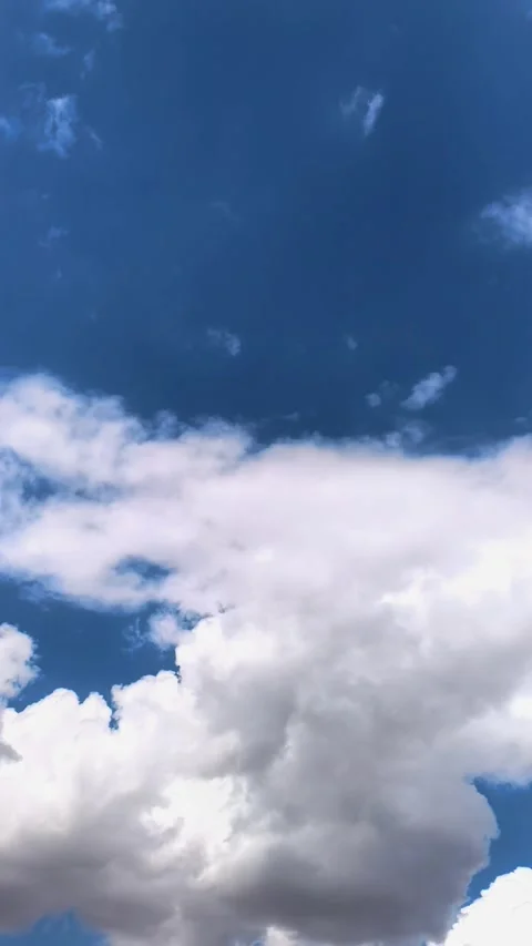 White clouds move across a bright blue sky in time lapse, natural weather Stock Footage 342112381