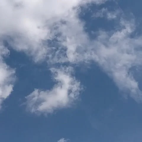 White clouds move across the sky in different directions Stock Footage 165553043