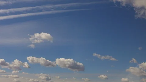 White clouds move against blue daytime sky Stock Footage 128024411