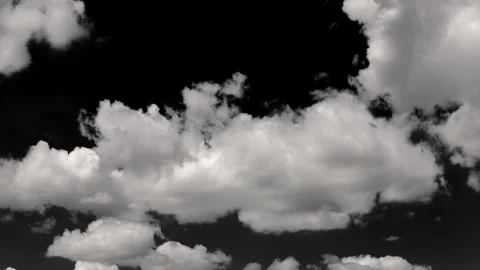 White clouds move rapidly across a black sky, captured in smooth motion. Stock Footage 318472713