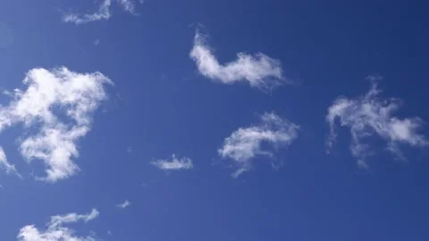 White clouds move slowly against the blue sky Stock Footage 134372531