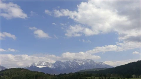 White clouds moves on the blue sky in alps Stock Footage 74655298