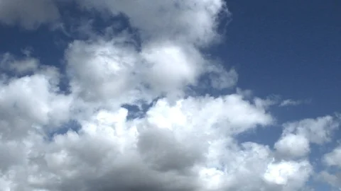White clouds moving across blue sky Stock Footage 106354264