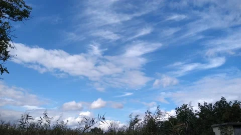 White clouds moving across the blue sky Stock Footage 161595207