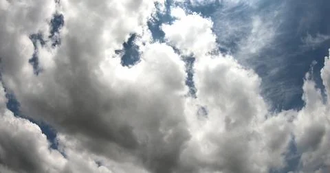 White Clouds Moving Across a Clear Blue Sky Stock Photos