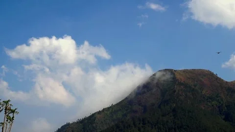 White clouds moving around the beautiful mountains Stock Footage 252572683