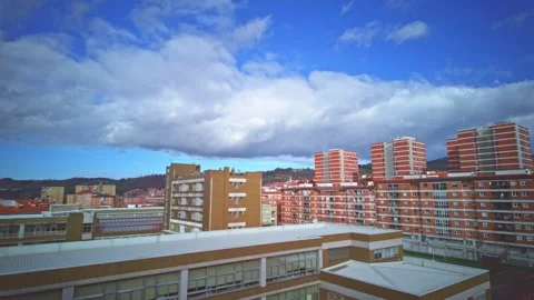 White clouds moving fast over city buildings timelapse Stock Footage 327421979