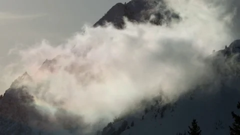White clouds moving near the snow covered mountains Stock Footage 77764977