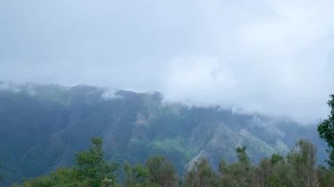 White clouds moving over the green mountain peaks Vídeo Stock 333696258