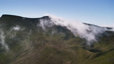 White clouds moving over green mountain peak Stock Footage 336772360