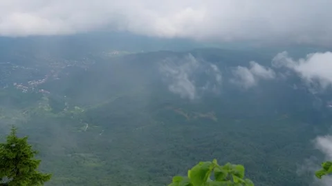 White clouds moving over a green mountain valley Stock Footage 343988216