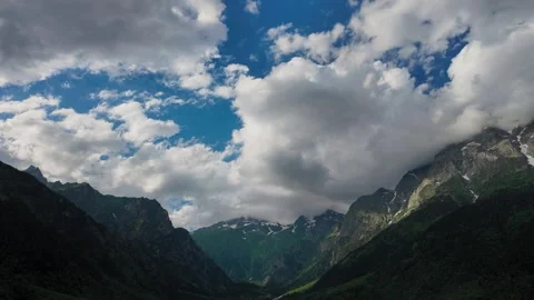 White clouds moving over a green mountain valley Stock Footage 344813687