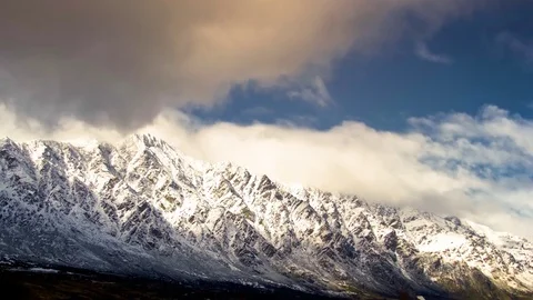 White clouds moving over snow covered mountains Video stock 76104983