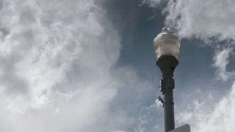 White clouds moving over street light Stock Footage 84505849