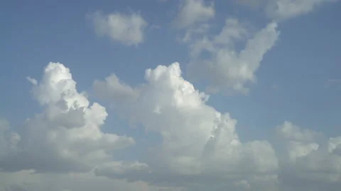 White clouds moving rapidly across the blue sky Stock Footage 230988561