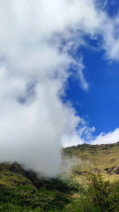White clouds moving in vertical video above the mountains. 4K Video stock 289090747