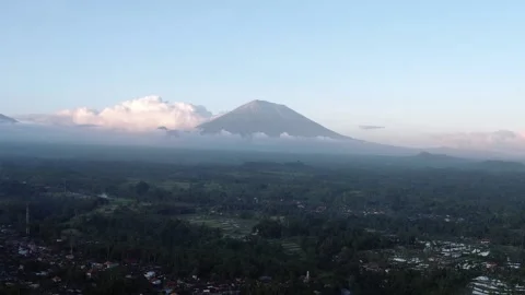 White clouds at one side of Agung mountain, dark landscape of Bali seen down Stock Footage 202537693